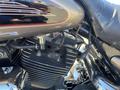 Close-up of a 2004 Harley-Davidson FLHTCUI engine showcasing chrome and black components with visible wires and tubing