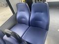 Two blue upholstered seats in a vehicle, designed for passenger comfort with a textured surface and curved backrests