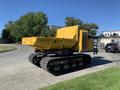 A yellow 2022 TerraMac RT7R tracked vehicle with a dump bed positioned on a concrete surface