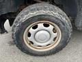 A close-up of a 2010 Ford F-150 tire showing the tread pattern and rim design