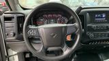 A close-up view of the steering wheel and instrument cluster of a 2021 International CV515 with various gauges and a central display in the dashboard