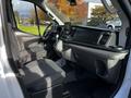 Interior of a 2020 Ford Transit featuring a driver's seat passenger seat and dashboard with a touchscreen display