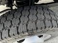 Close-up of a tire on a 2016 Ford F-550 showing deep treads and grooves designed for traction and stability on various surfaces