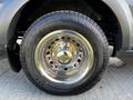 Close-up of a chrome wheel and tire from a 2017 Ford Transit showcasing its shiny rim and tread pattern