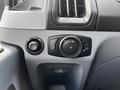 Dashboard controls of a 2018 Ford Transit featuring knobs for lights and door release