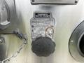 Close-up of a valve control labeled Master Take Valve with a chain attached and a manual override knob on a metallic surface