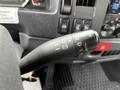 Close-up of the multifunction lever in a 2018 Isuzu NRR with symbols for turn signals headlights and wipers