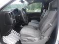 Interior view of a 2015 Chevrolet Silverado 1500 showing the front seats and dashboard with gray upholstery and a steering wheel