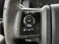 Close-up of the steering wheel controls of a 2016 Ford F-550 featuring buttons for info setup reset and volume adjustment