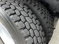 Close-up of the tread on a 2006 Freightliner M2 112 tire showcasing deep grooves and thick rubber for traction and stability