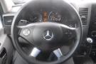 Steering wheel of a 2016 Mercedes-Benz Sprinter with controls and gauges visible in the dashboard display