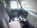 Interior view of a 2016 International WorkStar 7500 showing the driver's seat steering wheel and control panel with various buttons and levers