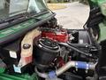 A 2015 Freightliner M2 106 truck engine showcasing various components including hoses a red engine block and an air intake system
