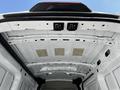 The interior roof of a 2021 Ford Transit showing metal framing and light fixtures