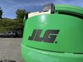 A green JLG 450AJ aerial lift with the JLG logo prominently displayed on its side