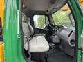 Interior view of a 2015 Freightliner M2 106 with two gray seats and a steering wheel visible from the driver's side