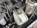 Close-up of the fluid reservoir labeled Washer Fluid Only on a 2012 Toro Groundsmaster 5910 surrounded by various engine components and hoses