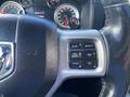 The steering wheel of a 2017 RAM 1500 featuring control buttons for gear adjustment and cruise control functions