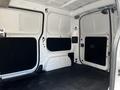Interior view of a 2020 Nissan NV200 cargo van showing empty space with black carpeting on the floor and gray walls