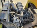 Engine components of a 2010 Kubota F3990 with various hoses and a cylindrical air intake visible