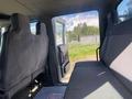 Interior view of a 2014 International 7400 featuring gray cloth seats and an open side door
