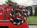 A 2001 Toyota Dyna truck equipped with firefighting equipment including a water pump and a large coiled hose mounted on the side