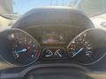 Dashboard of a 2014 Ford Escape showing speedometer fuel gauge and trip information display