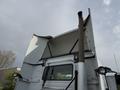 A 2012 Volvo VNL truck with a large raised sleeper cab and prominent exhaust stack visible at the rear