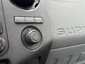 The interior dashboard of a 2012 Ford F-450 SD featuring control buttons and a 12V power outlet