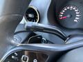 A close-up view of the gear shift lever and instrument panel of a 2019 Mercedes-Benz Sprinter showing speedometer and controls