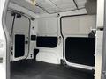 Interior view of a 2020 Nissan NV200 cargo van featuring empty space with white walls and a black floor