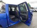 A blue 2019 RAM 1500 Classic pickup truck with an open rear door showing the spacious back seat and interior details