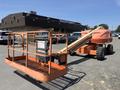 A 2008 JLG Boom Lift with an orange platform and extended boom positioned at an angle on a paved surface