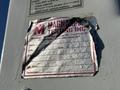 A worn label attached to a metal surface with details about a 2009 Ford F-550 crane including serial number and expiration date of inspection