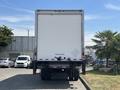 A 2015 Freightliner M2 106 box truck viewed from the rear with a blank white cargo area and a visible hitch at the bottom