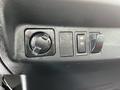 Dashboard controls of a 2020 Hino 338 including a power outlet and two switches for additional features