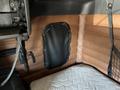 2022 Freightliner Cascadia interior corner with leatherette paneling and a quilted surface below a mounted storage net