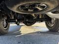A view of the undercarriage of a 2023 RAM 3500 showcasing the rear axle and tire from a low angle perspective
