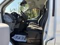 A 2016 Ford Transit with a spacious interior featuring two front seats and a driver's cockpit area