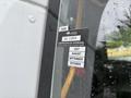 A 2020 Chevrolet Express van with a certificate of approval sticker on the window showing the months July August September and October