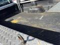 A 2013 Ford F-250 SD truck bed with a rubber liner showing dirt and debris on a diamond plate surface