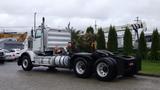 A 2019 Western Star Trucks 4900 with a white exterior and chrome accents parked with a visible chassis and dual rear wheels