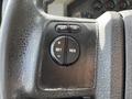 Close-up of the steering wheel controls of a 2008 Ford F-550 featuring buttons for cruise control with labels for on off set and resume