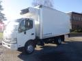 A white 2015 Hino 195 refrigerated box truck with a raised cooling unit on top and a side door for loading and unloading