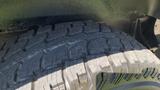 A close-up of the tire of a 2013 Ford Econoline showcasing the tread pattern and texture of the rubber