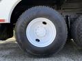 Close-up of a Bridgestone tire mounted on a 2008 International 7500 truck with a white rim and distinctive tread pattern