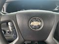 Close-up of the steering wheel of a 2017 Chevrolet Express featuring a prominent Chevrolet logo in the center and control buttons on the left side