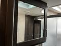 A mirrored cabinet with a dark frame interior storage space visible in the background showcasing the design of a 2021 Grand Design Recreational 311BHS