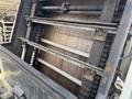 A close-up view of the interior mechanism of a 2015 Global Street Sweeper showing rotating brushes and metal components for street cleaning