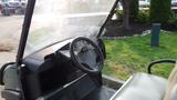 Interior view of a 2015 Club Car Carryall 500 featuring a steering wheel dashboard and seats designed for utility vehicle use